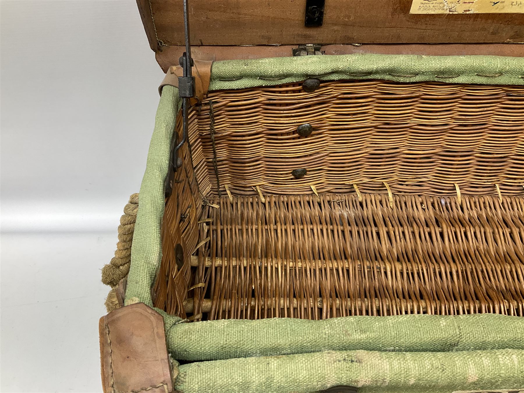 WW2 British Army RAMC 'Regimental Medical Pannier', well marked externally and dated 1941, stamped May 1943 internally, canvas covered wicker form with leather edges, hinged top and fall front with two rope carrying handles, fitted iron locking straps with securing chains; contains various unused field dressings and bandages with WW2 dates and two pillows; original label under lid L79cm