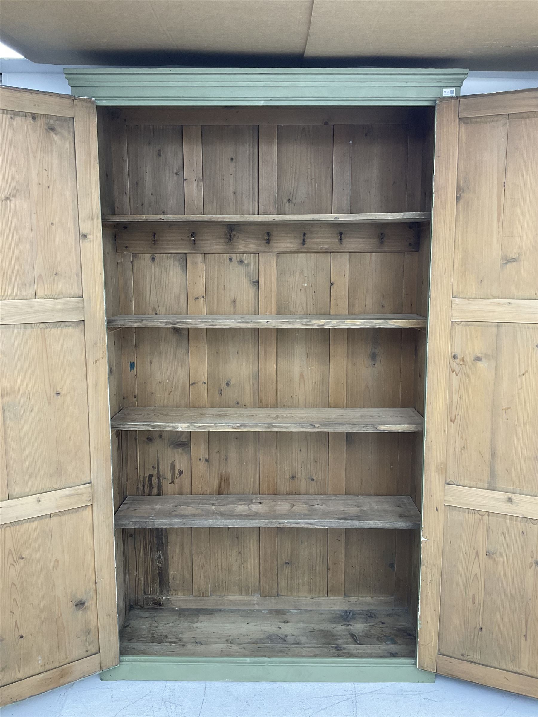 Painted pine cupboard, two panelled doors enclosing four shelves, in laurel green finish