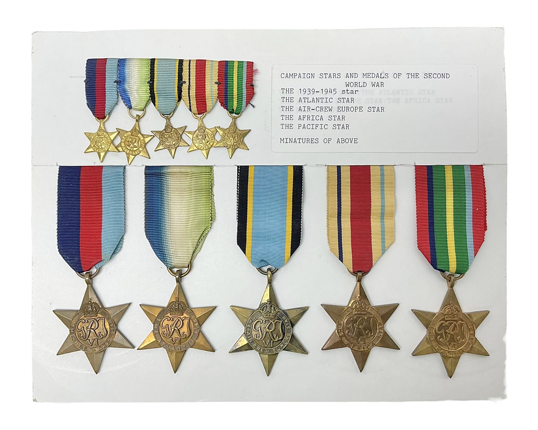 Representative display of WWII Campaign stars comprising 1939-1945 Star, Atlantic Star, Air-Crew Europe Star, Africa Star and Pacific Star; together with the corresponding group of miniatures; all with ribbons