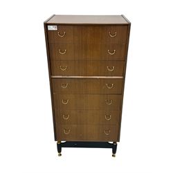 G-Plan teak tallboy, seven drawer chest with brass loop handles, ebonise base with adjustable brass terminals
