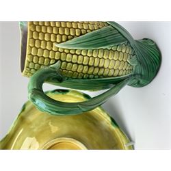 A Victorian majolica bread plate depicting corn within a woven basket, L33cm, together with a Victorian majolica jug modelled in the form of a corn cob, with registration mark beneath, H22cm. 