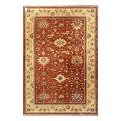 Late 20th century Royal Keshan 'Agra' hand-knotted wool rug, terracotta ground with central floral medallion and scrolling vines, enclosed by a cream border with repeating floral motifs