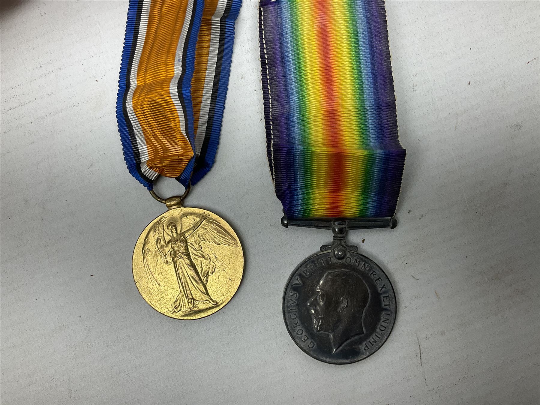 Pair of WWI medals, comprising British War medal and Victory medal, both with ribbons