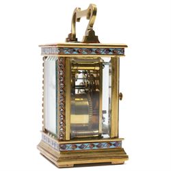 French- Edwardian miniature brass 8-day timepiece carriage clock with cloisonné panels to both base and cornice and paste gems to the front columns, decorative porcelain dial with a floral swag, blue Arabic numerals, minute track and pieced steel hands, square viewing glass to the top with a silvered lever escapement, with original leather bound traveling case.