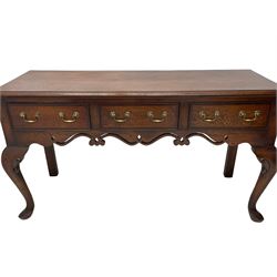 Georgian design oak and mahogany dresser base, the rectangular moulded top with mahogany band, three cocked-beaded and banded drawers over shaped a pierced apron, circular brass handle plates and swan neck handles, on C-scroll carved cabriole supports 