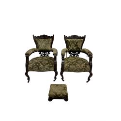 Pair late 19th century mahogany salon armchairs, scrolled cresting rail with cartouche design, carved and pierced back support, upholstered in patterned olive green fabric with sprung seat, on cabriole supports with ceramic castors; with matching footstall