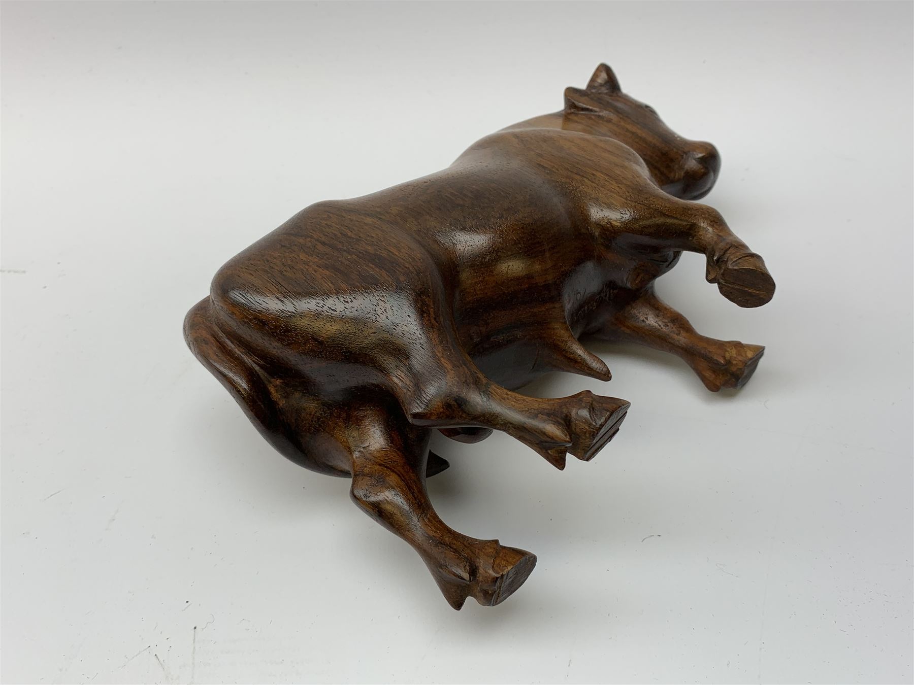Ann Baxter (British b. 1969): a carved wooden model of a Bull, signed beneath A.W. Baxter, L22cm x H14cm 