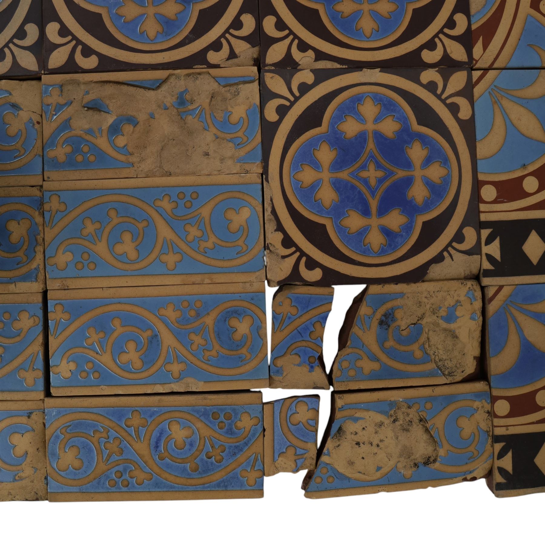 Minton & Co, Gothic Revival polychrome encaustic floor tiles, circa 1850, including six decorated with a central cardinal quatrefoil upon a blue ground, boarder tiles with scrolling vines and similar