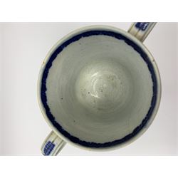 Late 18th century blue and white pearlware loving cup, the bell shaped bowl inscribed Thomas Holms 1796, and further detailed with floral motifs bellow a diamond hatched band, raised upon a circular spreading base, H13.5cm