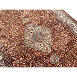 Persian amber ground rug, the central shaped pole medallion surrounded by scrolling foliate decoration with extending branches, the multi-band ivory border decorated wit repeating palmettes