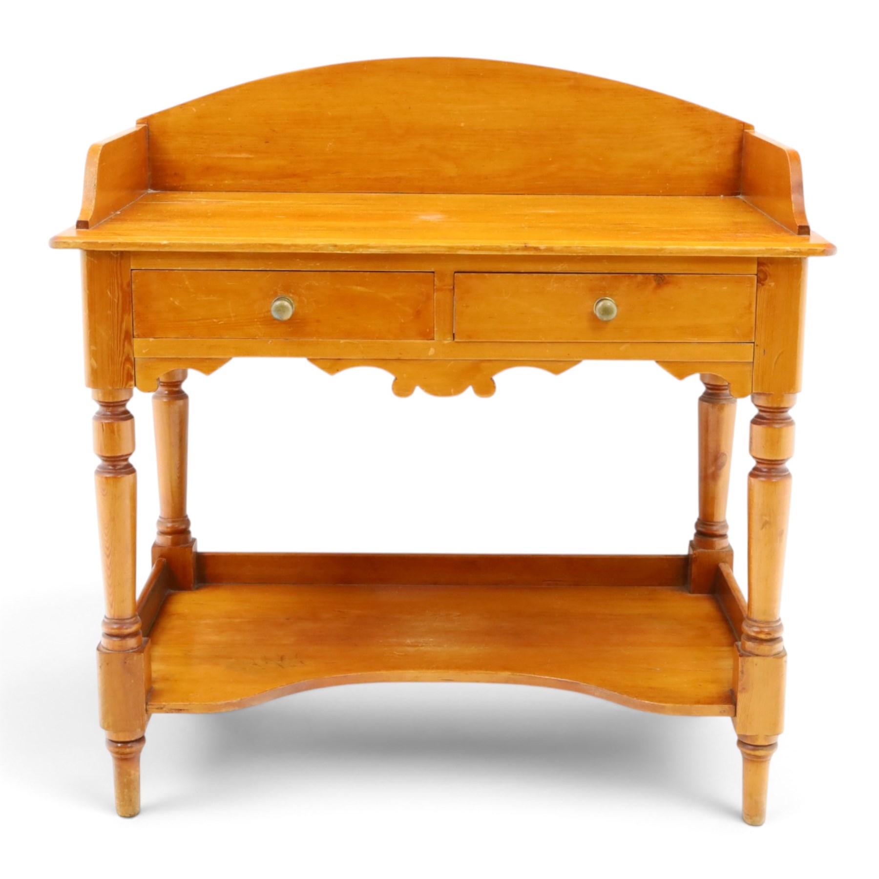 Victorian pine washstand, raised three quarter galleried top, fitted with two drawers, raised on turned supports united by a shaped full length under tier 
