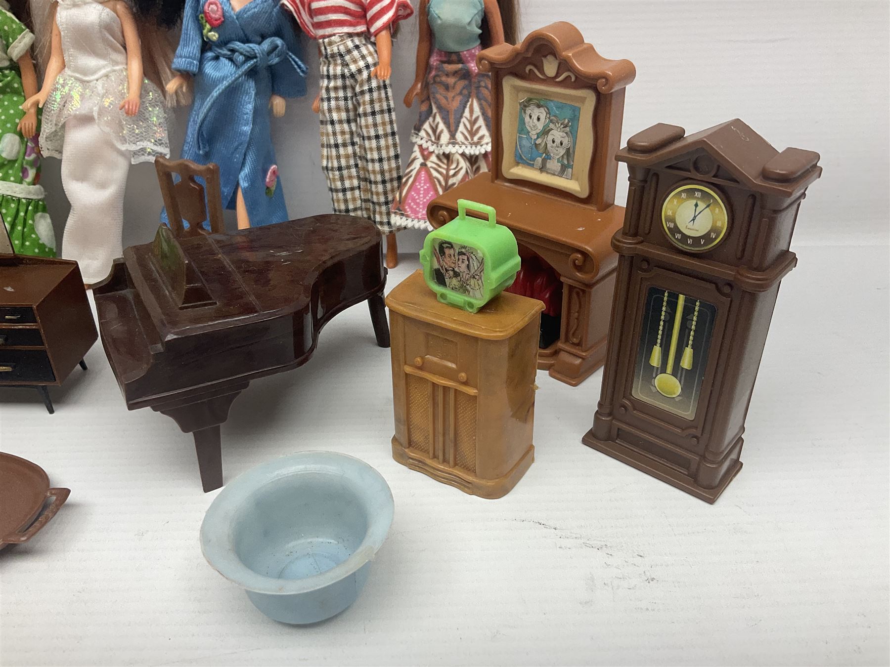 Seven Pippa dolls and a collection of plastic dolls house furniture