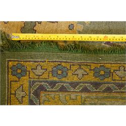 Lage Turkish Oushak green ground carpet, the field decorated with large stylised plant motifs and geometric design, the sage green guard band with further repeating foliate motifs