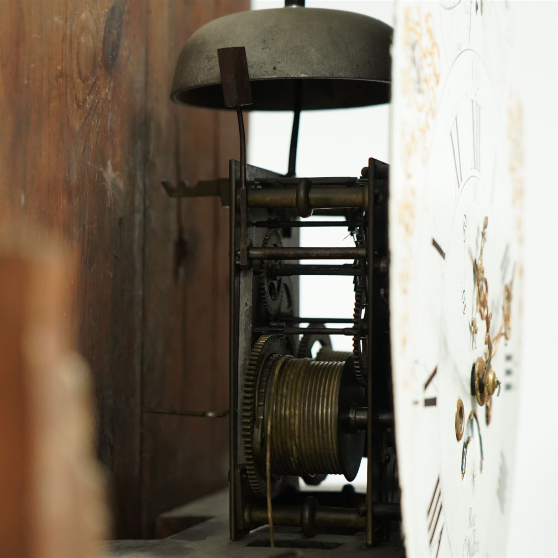 Rea of Walton on Trent (Derbyshire)-8-day Oak cased Longcase clock c1810, case with a swan necked pediment, brass parterre and a ball and eagle brass finial, bespoke hood door flanked by reeded pilasters with brass capitals, trunk with conforming recessed quarter columns and twin spire topped door, on a square plinth with canted corners and an optional detached base, comparatively rare painted oval dial with gesso decorated spandrels and a moon dial to the arch, chapter with Roman numerals, minute markers and Arabic quarter minutes, matching stamped brass hands with a subsidiary seconds dial and date aperture, dial pinned via an 