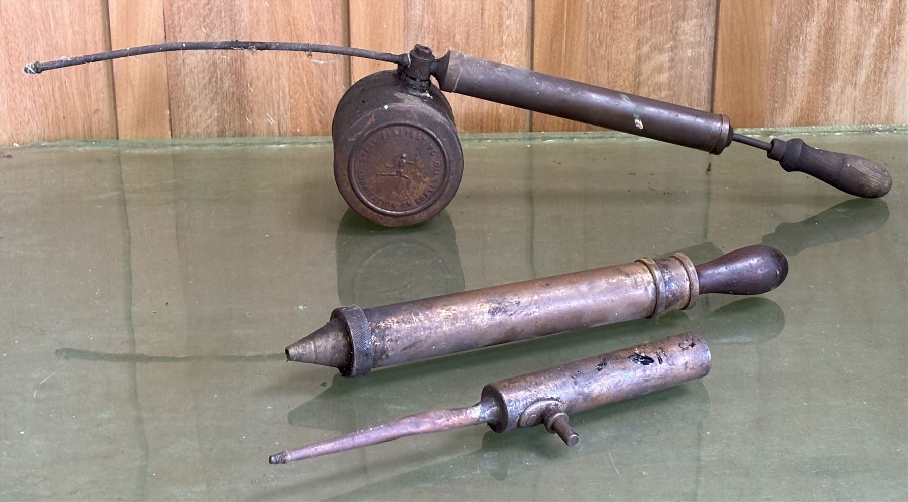 Rare early Shell advertising brass penetrating oil can, the can embossed to each side with the stick / robot man motif, and reading 'Penetrating oil can lubrication by Shell' (L71cm) together with two other early motoring oil hand pumps, one signed 'Erot' and the other 'Nesthill Royalty PAT.' (3) - COLLECTION BY APPOINTMENT FROM: The White House, Thirsk Road, Easingwold, York, YO61 3NF - CALL 01723 507111 TO ARRANGE