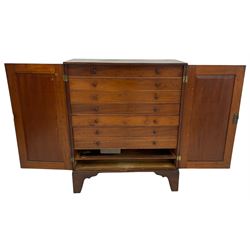 19th century mahogany collector's cabinet, crossbanded rectangular top over two panelled doors, the interior fitted with seven shallow drawers, on bracket feet