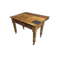 Traditional rustic pine dining table, rectangular top fitted with two drawers, raised on turned tapering supports on ceramic castors