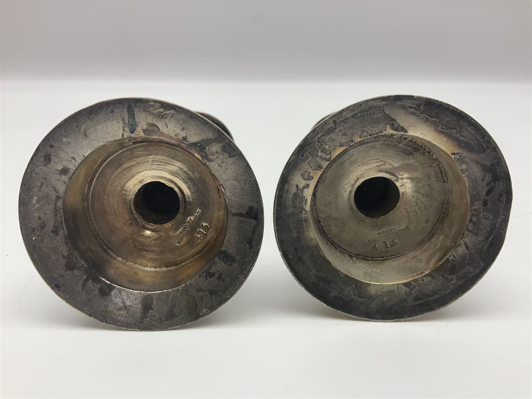 Pair of Victorian Elkington Mason & Co silver plated candlesticks, decorated in relief with ram masks and figures, H14cm