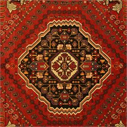 Persian Shiraz rug, hand-knotted tribal rug, bold geometric central medallion, set within a large hexagonal crimson field with angular stepped corners in dark blue, with boteh motifs, rosettes, and other tribal symbols arranged in diagonal rows, the corners with indigo spandrels decorated with zoomorphic and arboreal motifs, main border composed of a floral meander motif with large rosette, flanked guard borders with vine and leaf motifs 