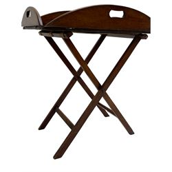 George III mahogany butler's tray on stand, the panelled tray with hinged sides pierced with handles, on folding stand