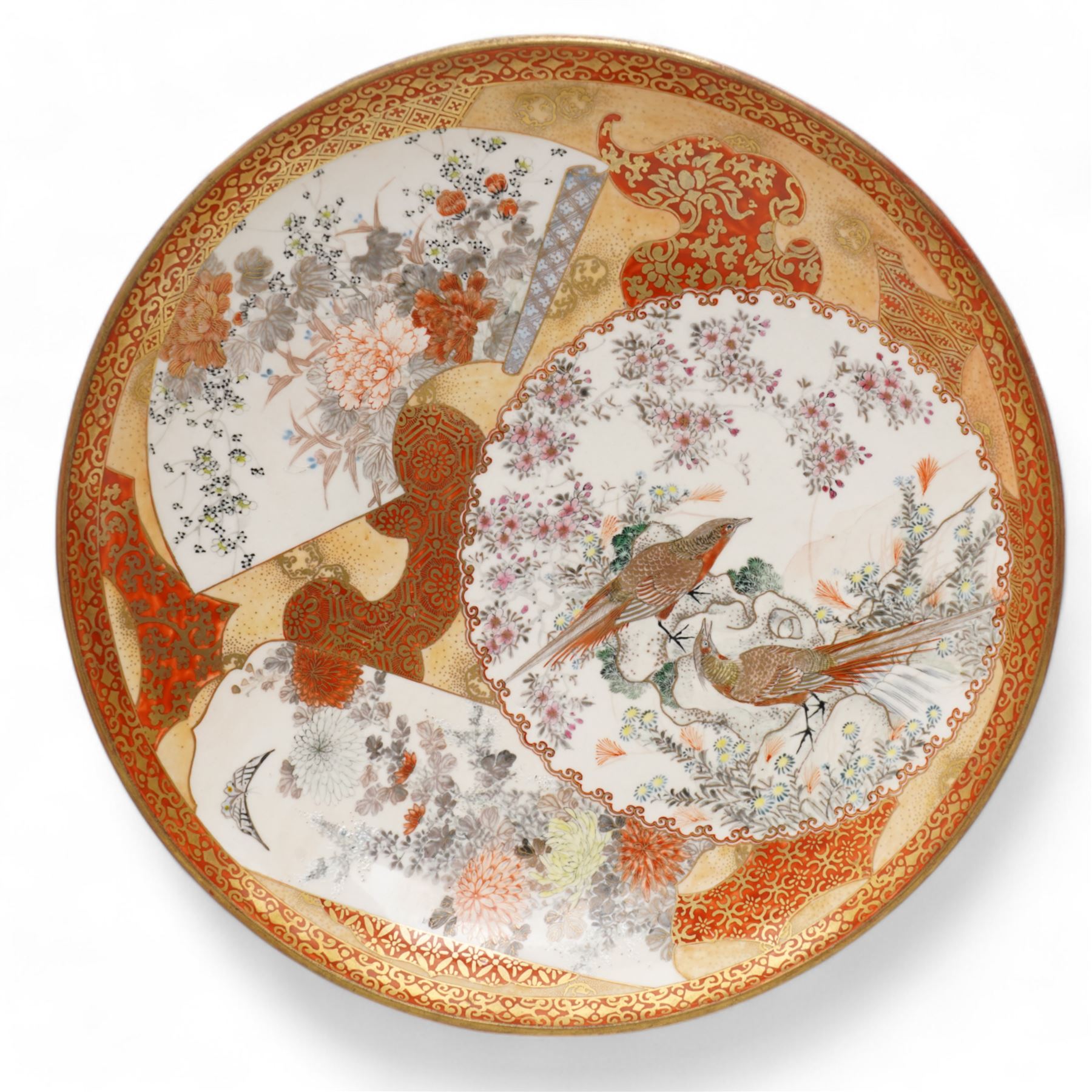 Japanese Meiji Kutani shallow bowl decorated with birds with fan shape and circular panels in orange and gilt, character mark to base D30cm and another Japanese bowl decorated with a centre panel of figures in orange, gilt etc D30cm (2)