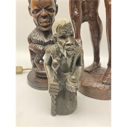 Pair of 20th century carved wood table lamp with African busts and figures, together with a carved wooden figure and soapstone figure, lamps H44cm