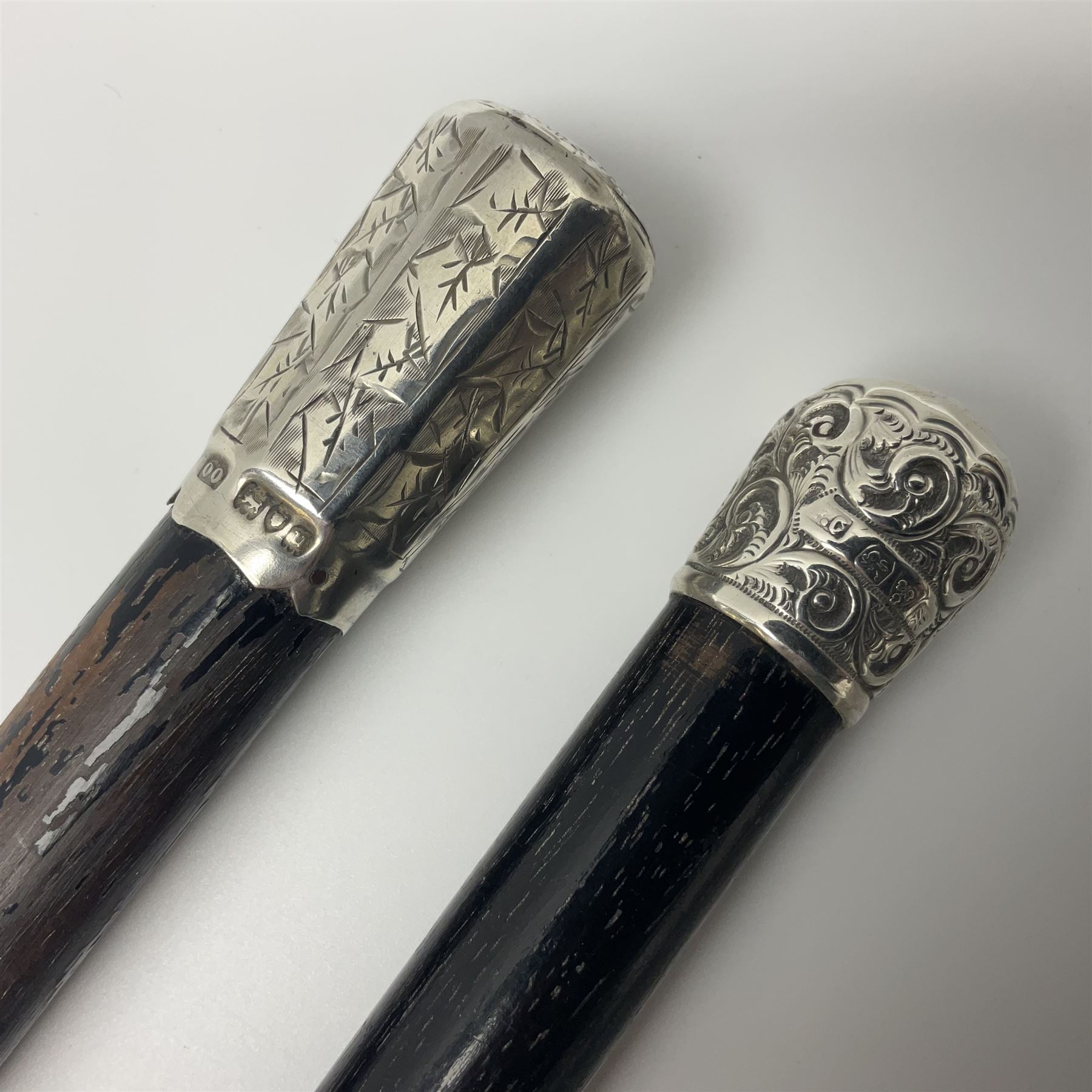 Two early 20th century conductor's ebonised batons each with three silver mounts; one hallmarked London 1915 with presentation plaque 'I.O.R. Presented to Mr. J.R. Maddock 4.1.17' L52cm; the other hallmarked Chester 1908 with vacant cartouche L51.5cm (2)