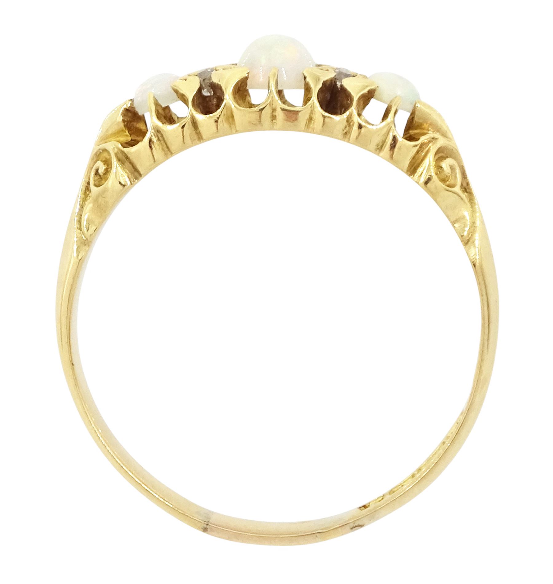 Edwardian 18ct gold opal and diamond ring, three cabochon cut opals, the principal stone with two round cut diamonds set either side, Birmingham 1910