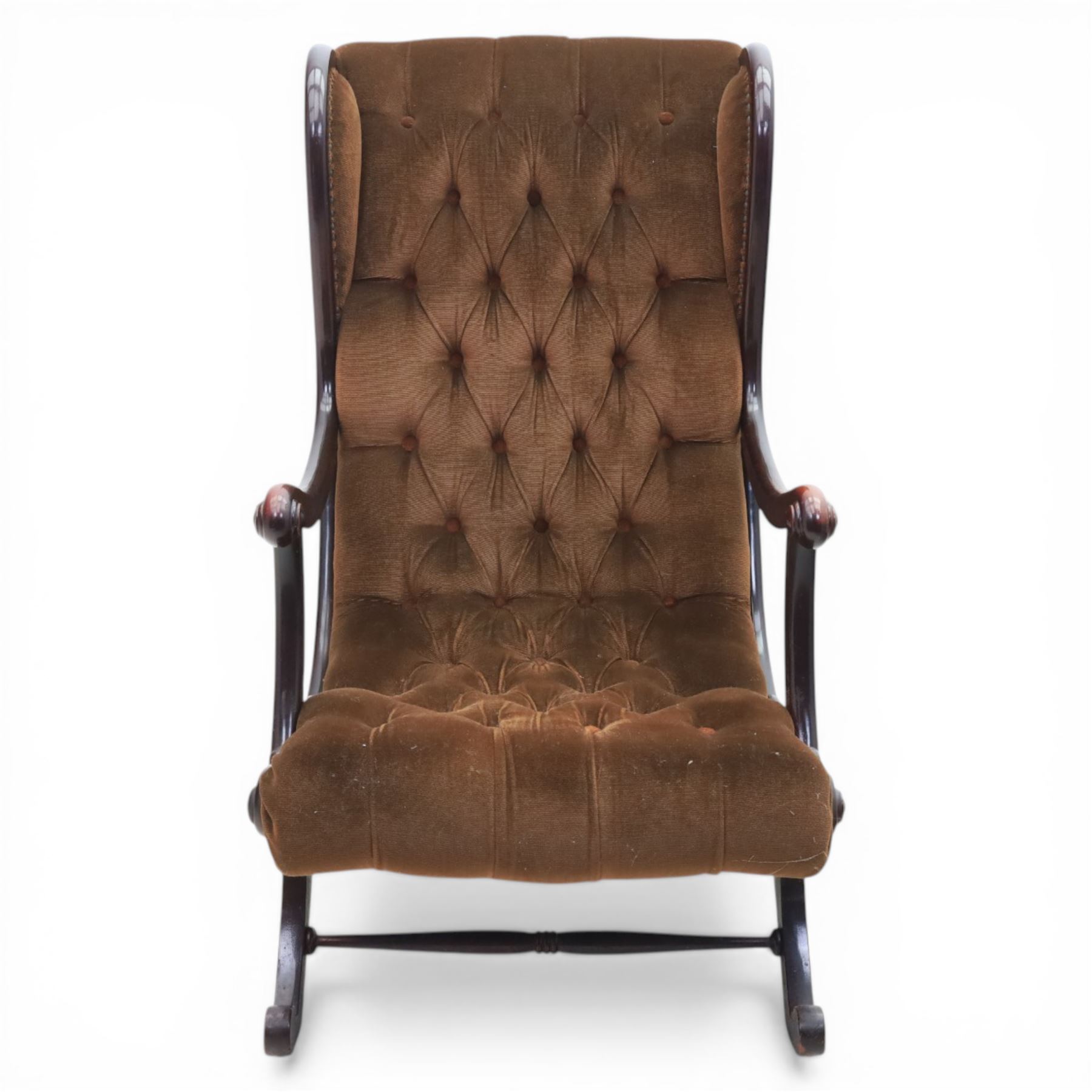 Late 20th century Regency style mahogany framed reading chair, the shaped and moulded frame with scrolled arms and open sides, upholstered in buttoned brown velvet, raised on curved supports terminating in scroll feet