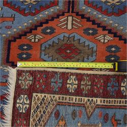 Caucasian Kazak hand-knotted rug, pale blue main field with large geometric medallions in a vertical arrangement and angular tribal motifs within a rosette and geometric border, cotton fringe end, 68x88cm