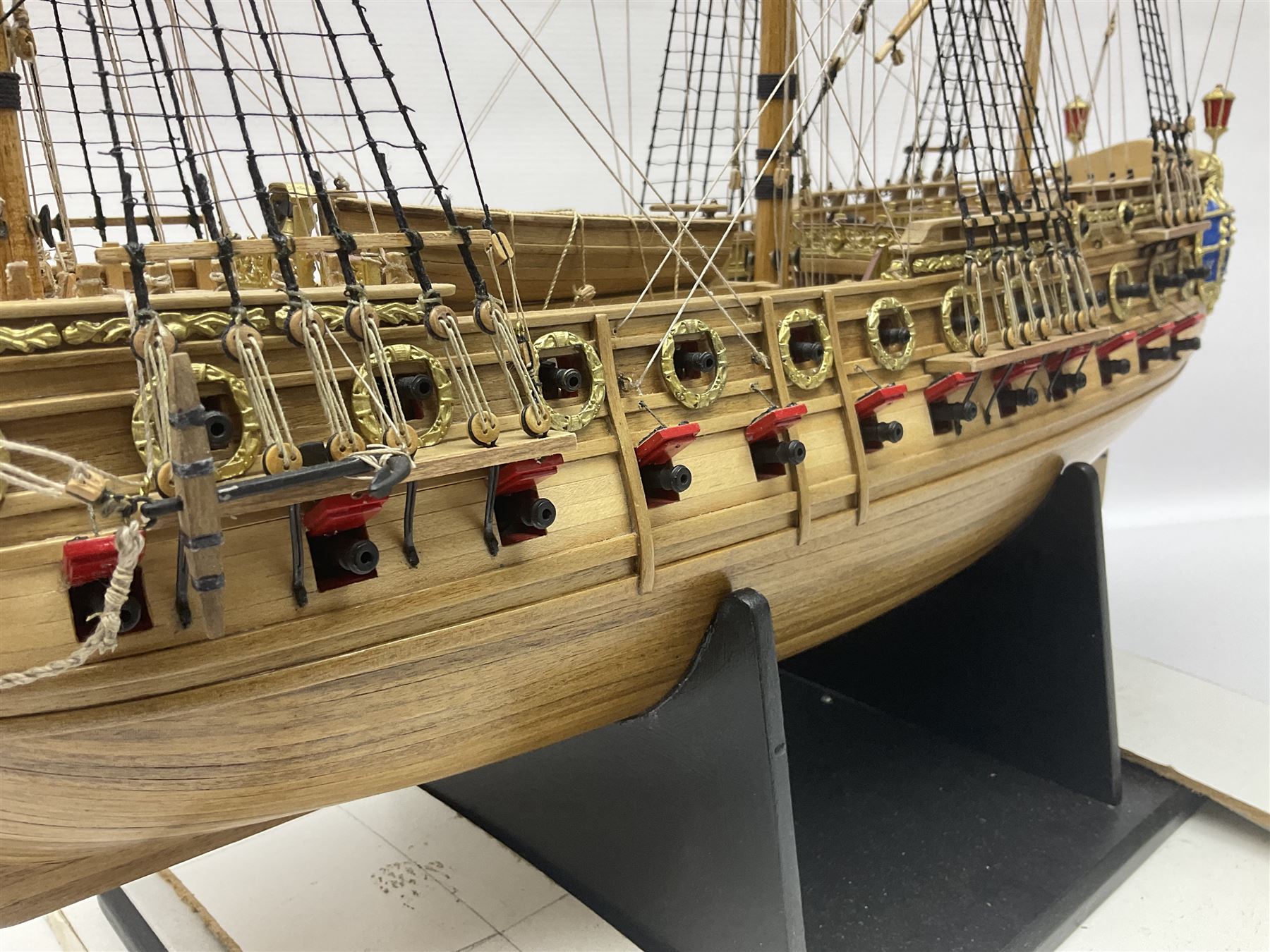 Wooden kit built model of HMS Neptune, 1:90 scale, with detailed rigging to three masts and a row of cannons to either side, upon ebonised wooden base, including stand H71cm