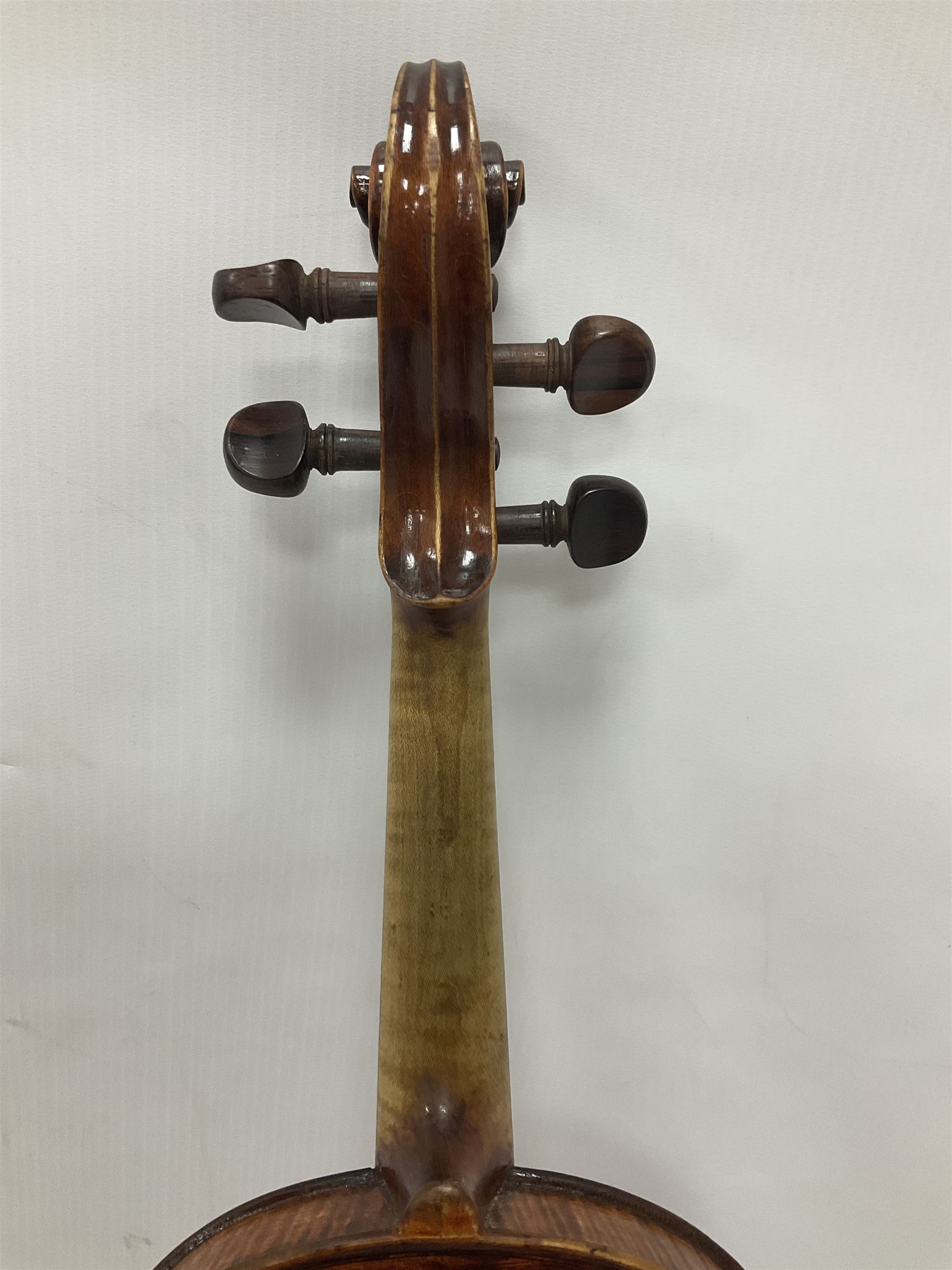 19th century full sized violin in a later hard case, decorative mother of pearl inlay to the tail piece Overall length 60cm No bow