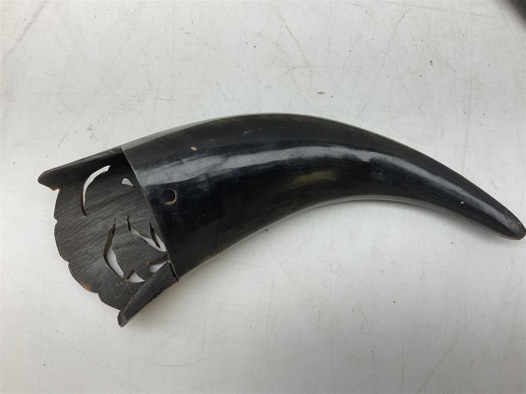 Carved water buffalo horn wall pocket, engraved with landscape scene with patterned borders with pierced foliate panel, together with a pair of horns with similar engraved decoration, L47cm