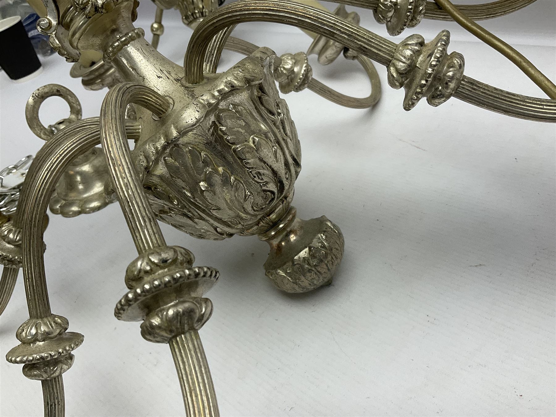 Siz branch silvered chandelier, decorated with acanthus leaves and putti, together with two matching three branch wall sconces, chandelier D65cm