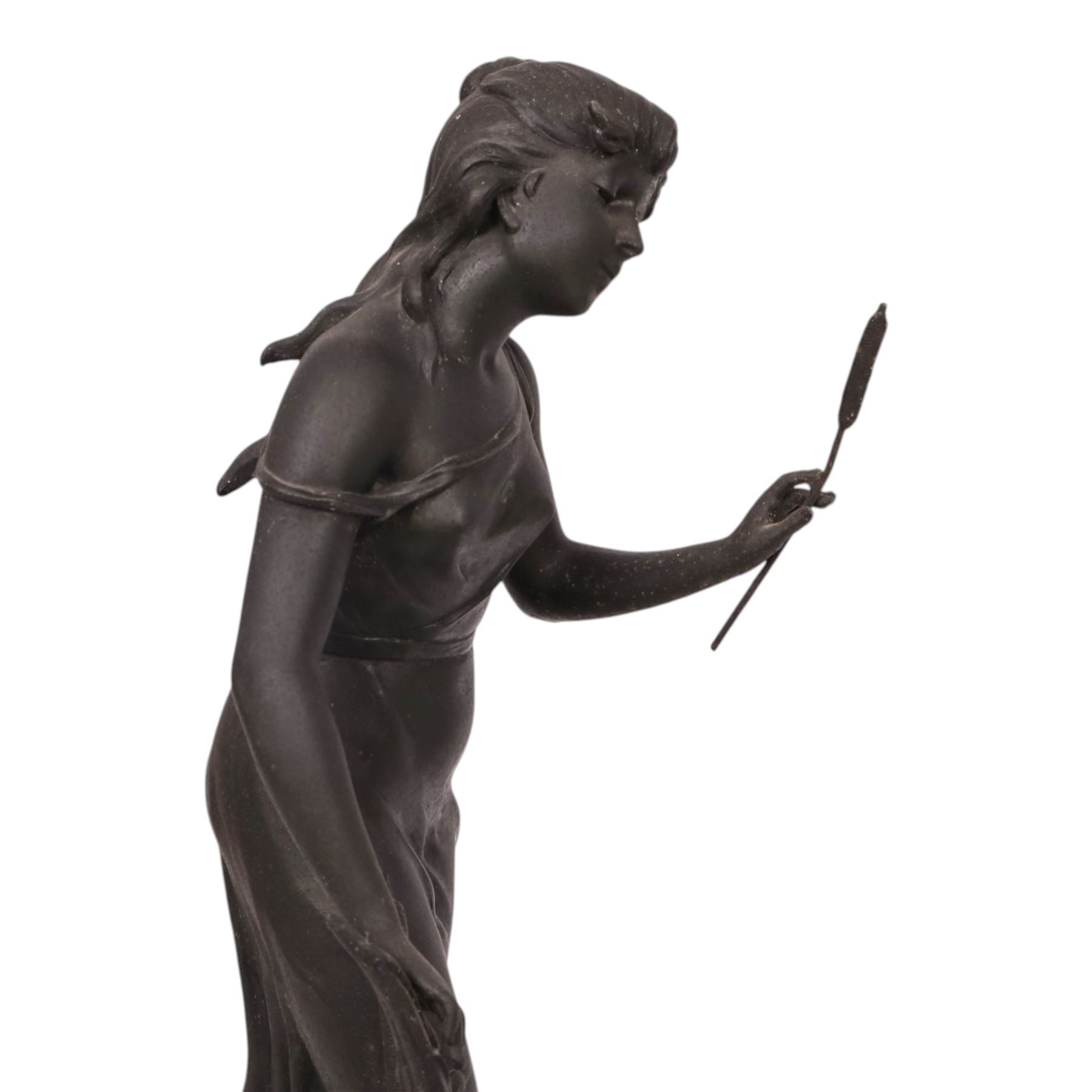 French green onyx clock, surmounted by a female figure amongst rushes, the enamel clock face with floral sprigs, H74cm 