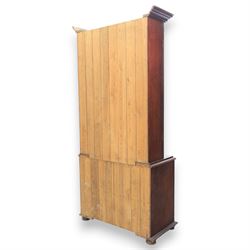 20th century mahogany display bookcase, projecting moulded cornice over a pair of glazed doors with shaped upper glazing and plain lower panes, opening to reveal shelved interior, the base with two recessed panel cupboard doors, raised on a moulded plinth with compressed bun feet