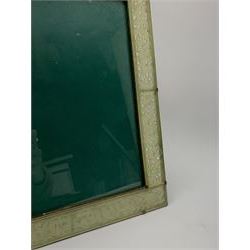 Early 20th century Chinese jade mounted photograph frame, of rectangular form the pierced jade frame carved with flowers and birds, the top panel carved with Foo dogs flaking an applied carved lavender coloured boss, with easel support verso, H33cm
