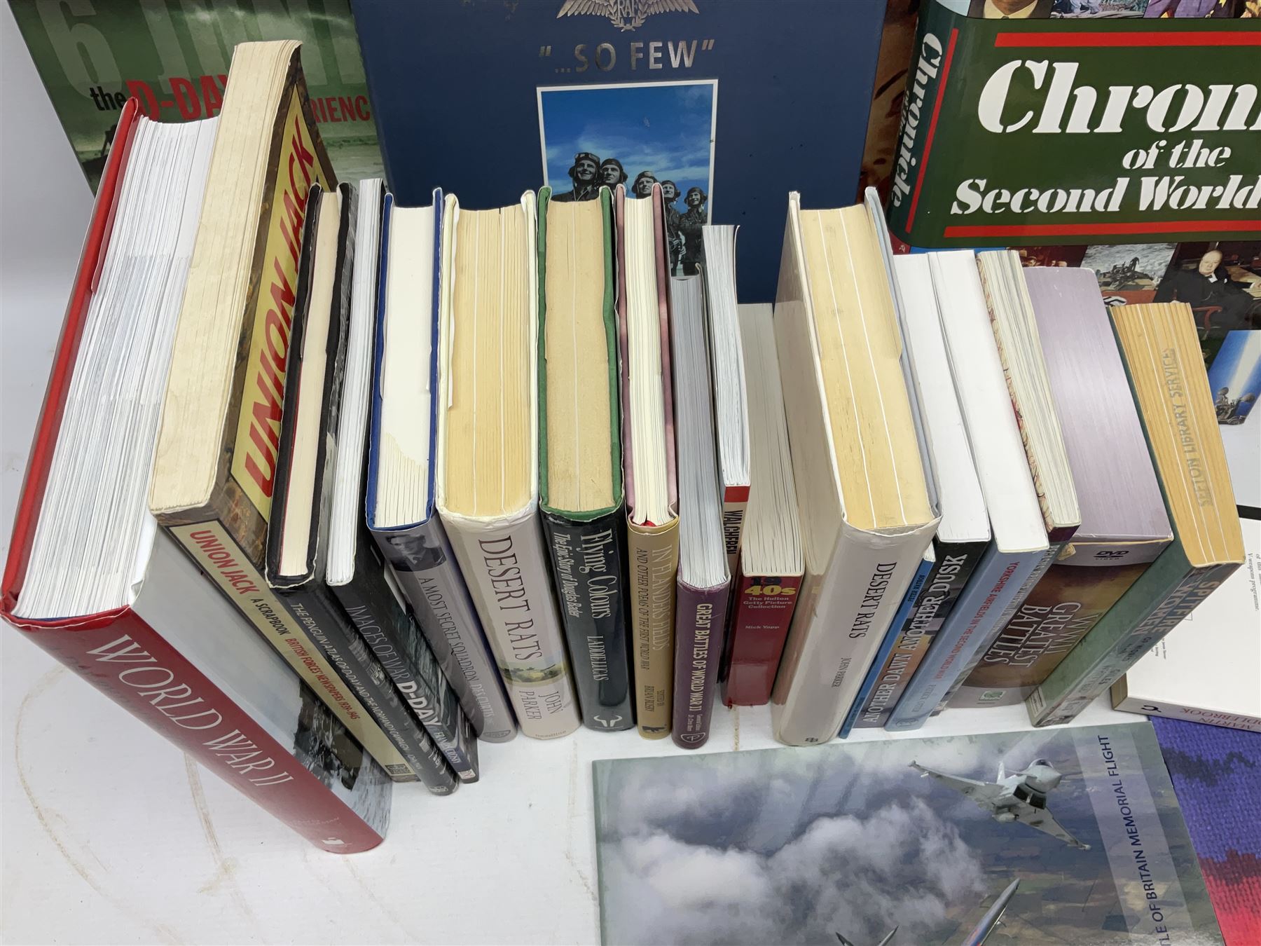 Thirty modern books of military interest including The Wartime Scrapbook 1939-1945; D-Day by Stephen Badsey; The D-Day Experience by Richard Holmes; Desert Rats by John Parker; A Most Secret Squadron by Des Curtis; Flying Colours - The Epic Story of Douglas Bader by Laddie Lucas etc; and quantity of DVDs of war and military interest