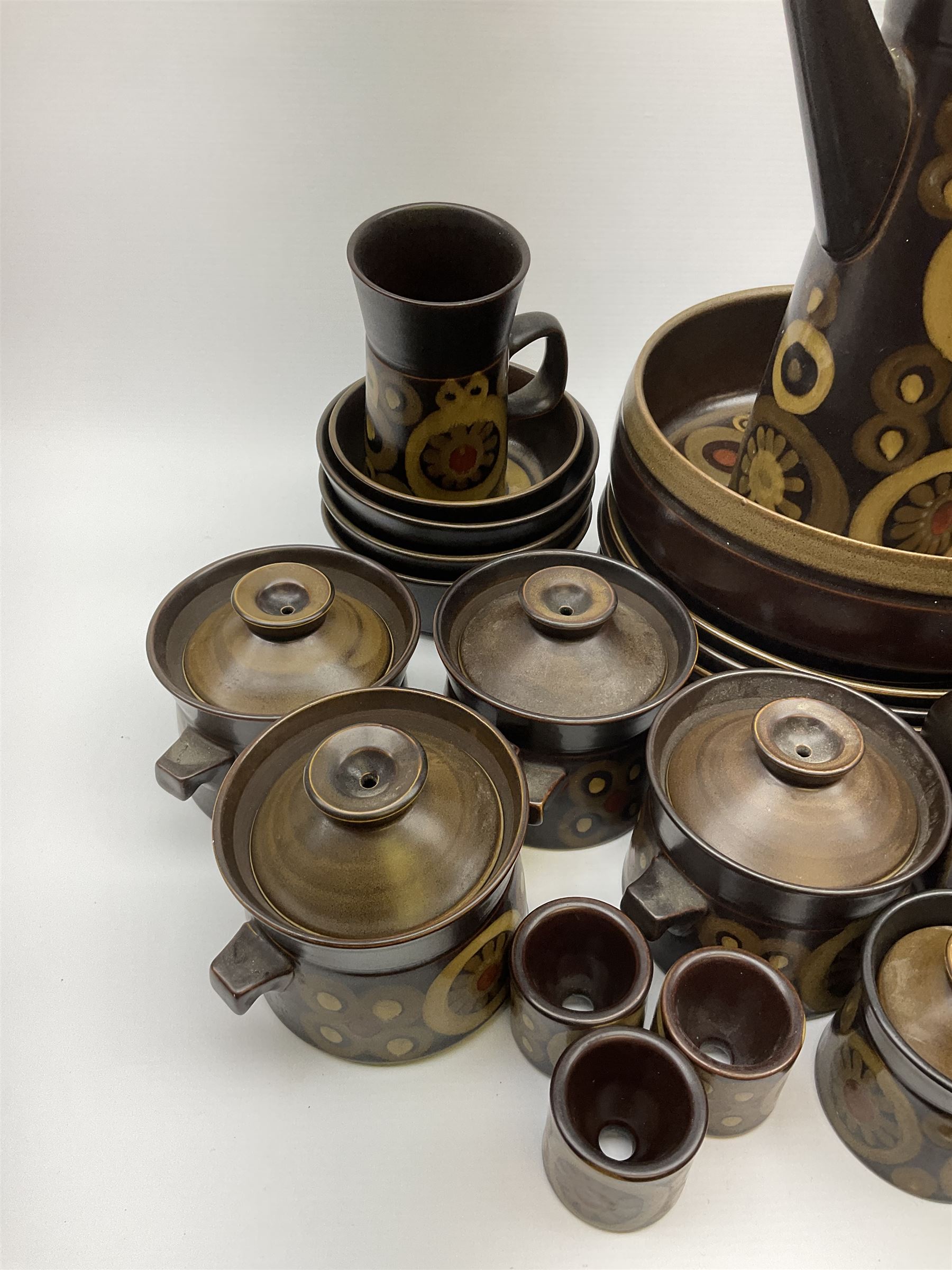 Denby Arabesque pattern tea and dinner wares, comprising large serving bowl,  five dinner plates, three side plates, four twin handled bowls and covers, one bowl and cover, four bowls, salt and pepper shaker, pan with lid, six egg cups, small serving dish, coffee pot, water jug, milk jug, jug with handle,  two sucriers and covers, four tea cups and one coffee