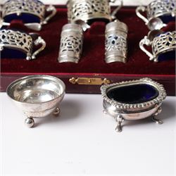 Set of four Edwardian pierced silver salts and matching mustard pot, all with blue glass liners Birmingham 1901 Maker William Devenport, cased, together with a pair of similar pepperettes 1900 Maker Walker & Hall, Georg Jensen sterling silver cauldron shape salt on ball feet, plated coaster, plated salt and silver topped jar