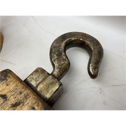 Three ship pulleys comprising wooden block double with swivel eye marked 'wooden block 240mm double rope: 22mm',  wooden block double with upset shackle and wooden block with stiff swivel hook, largest example L50cm