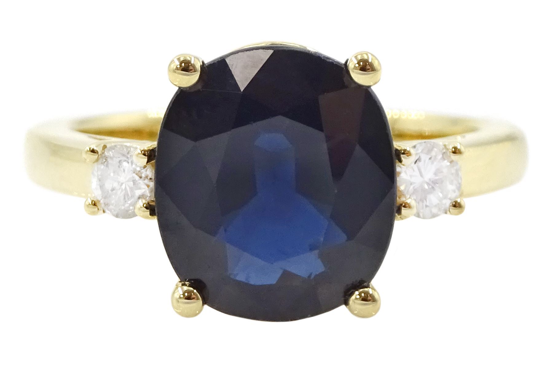 18ct gold sapphire and diamond three stone ring, single oval cut sapphire of approx 3.45 carat, with a round brilliant cut diamond set either side, hallmarked