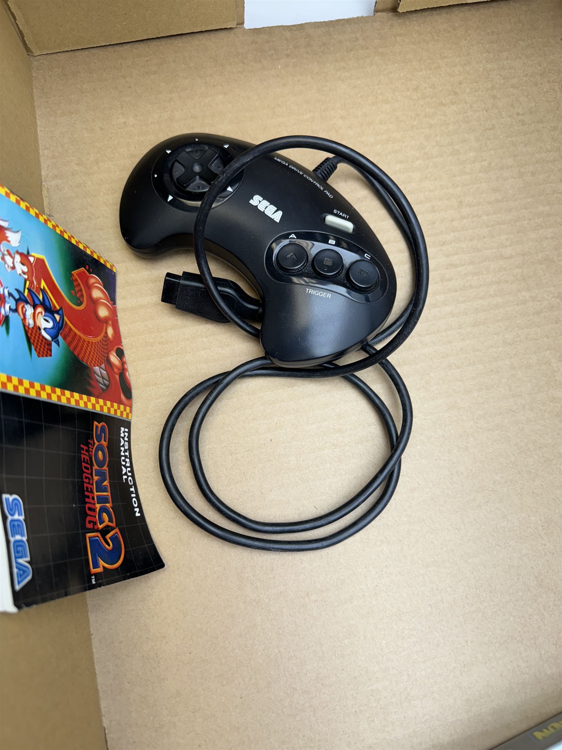 Eighteen Sega Mega Drive games, including Sonic The Hedgehog, Sonic The Hedgehog 2, Alienstorm, Desert Strike, Fatal Rewind, Road Rash etc, all boxed, together with a Sega Mega Drive controller, cartridge converter and an arcade power stick controller