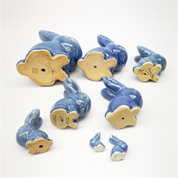 A collection of eight Denby blue glazed models of the Rabbits Marmaduke and Cotton tail, various sized, largest H20.5cm, some marked.
