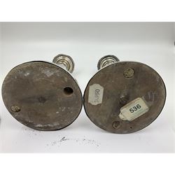 Four George III silver candlesticks, each upon knopped stem and weighted circular stepped foot, the foot and removable sconce repousse decorated with a band of flower heads, hallmarked to sconce and foot Thomas & John Settle, Sheffield 1820, H17.5cm