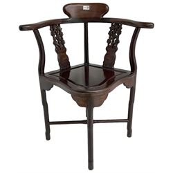 Chinese carved hardwood corner chair, outswept arms over pierced and carved floral splats, raised on shaped cylindrical supports united by X-stretcher