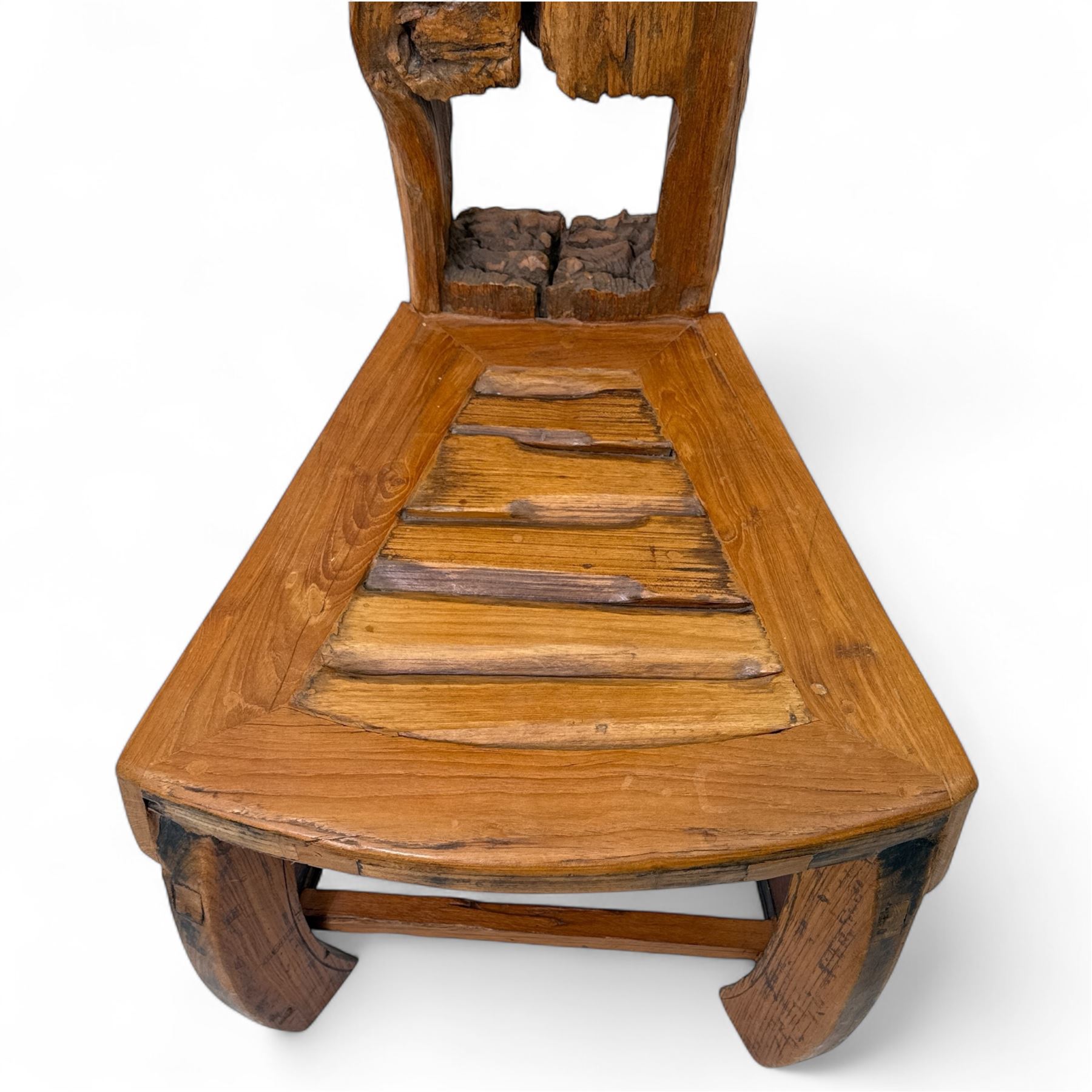 20th century driftwood sculptural hall chair, solid triangular seat over shaped apron, high ladder back formed from weathered and irregular timber, raised on curved legs united by H-stretcher