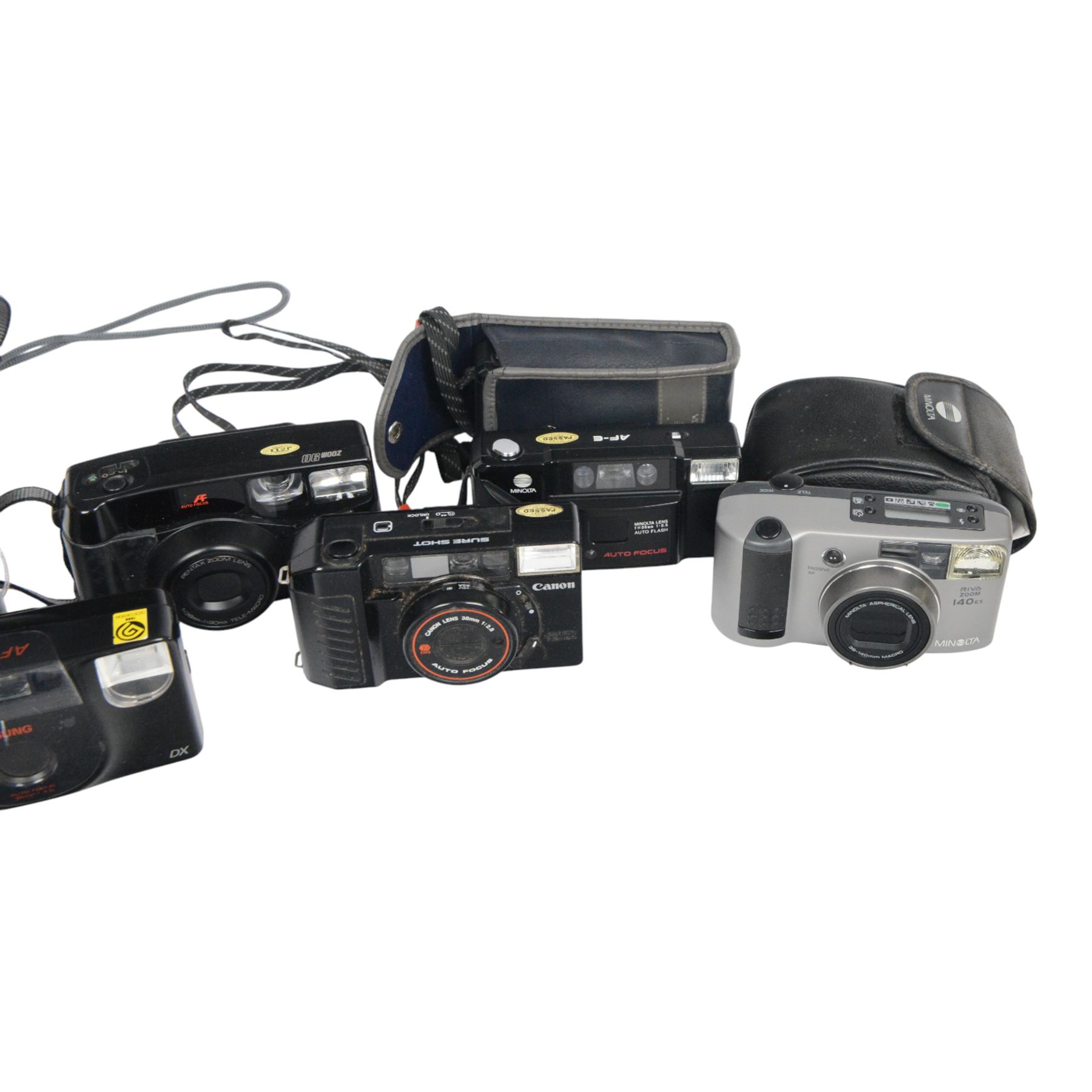 Collection of cameras including two Minolta AF-E, Pentax Zoom 90, Samsung AF 200, Pentax Espio 120Mi, Yashica Microtec Zoom 70, Canon Sure Shot and Minolta Riva Zoom 140 EX