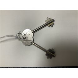 Grey steel wall mounting gun cabinet to accommodate three guns; single door with two locks with two keys for one lock; internally H128.5cm W21cm D17.5cm; externally H129cm W21.5cm D20cm