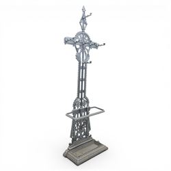 Late 19th century cast iron hall stand in the style of Christopher Dresser, cross shaped upper section with radiating wheel motif and applied hooks, architectural upright with pierced Gothic and geometric detail, fitted with rectangular drip tray and pierced surround, raised on stepped plinth base with bead decoration